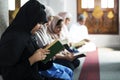 Muslims reading from the Quran