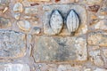 Mussel shaped relief sculpture at an stone wall