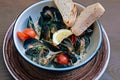 Mussels dish with some bread and little tomatoes Royalty Free Stock Photo