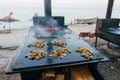 Mussels and fish frying at beach Royalty Free Stock Photo