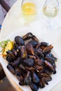 Mussels in shell with lemon in plate on table