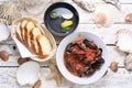 Mussels in tomato sauce, served with bread, top view. Clams in a bowl, on white wood background. Royalty Free Stock Photo