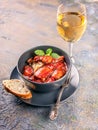 Mussels in tomato sauce and spaghetti and a glass of white wine. Mussels pasta. Mediterranean Kitchen