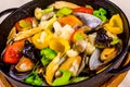 Mussels with vegetables in black pot Royalty Free Stock Photo