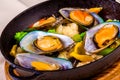 Mussels with vegetables in black pot Royalty Free Stock Photo