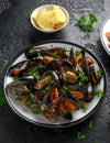 Mussels with white wine, garlic, lemon and herbs in a plate, French fries. rustick background. Seafood. Royalty Free Stock Photo