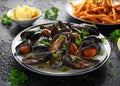 Mussels with white wine, garlic, lemon and herbs in a plate, French fries. rustick background. Seafood. Royalty Free Stock Photo