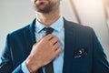 It must be perfect. an unrecognizable young man putting on a tie in his bedroom at home. Royalty Free Stock Photo