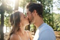 This must be what love feels like. a couple sharing a kiss while spending time together outdoors.