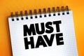 Must Have text quote on notepad, concept background Royalty Free Stock Photo