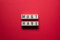 Must Have - word concept on cubes Royalty Free Stock Photo