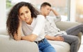 He must love. a young couple sulking after an argument at home on a sofa. Royalty Free Stock Photo