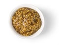 Mustard in round dish from above on white. Royalty Free Stock Photo