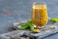 Mustard sauce in a glass jar and fresh basil. Royalty Free Stock Photo