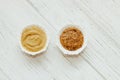 Mustard sauce and grain mustard in a white bowl on a white table. Royalty Free Stock Photo