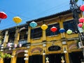 Mustard yellow building with traditional lamp at Hoi An ancient town, Vietnam