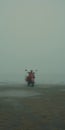 Muted And Dreamlike: Red Scooter On Foggy Beach