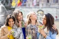 Muti ethnic group of female friends having fun drinking cocktails outdoor in the city in bar restaurant Royalty Free Stock Photo