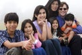 Mutiracial family sitting on beach Royalty Free Stock Photo