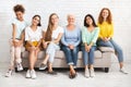 Mutiracial Ladies Of Different Age Sitting On Couch Posing Indoor Royalty Free Stock Photo