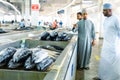 MUTRAH, OMAN - NOVEMBER 14, 2022: Vendors selling tuna, sardines and other fish species at fish souk in Mutrah. Oman.