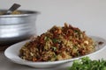 Mutton Biryani prepared with spices layered between mildly spiced ghee rice with a generous sprinkle of caramelized onions and