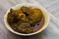 mutton curry and potato served in a bowl. the dish cooked in traditional indian style. spicy red gravy and potato is accompanied. Royalty Free Stock Photo