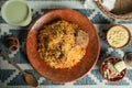 Mutton Kacchi biryani with salad, borhani and Chui Pitha served in dish isolated on mat top view of indian and bangladeshi food