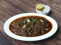 Mutton kheema curry or lamb kheema curry, spicy and delicious dish served over a rustic wooden background, selective focus Royalty Free Stock Photo