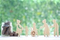 Mutual fund,Love couple senior and people on wheelchairs.pregnant woman with stack of coins money in glass bottle on natural green Royalty Free Stock Photo