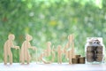 Mutual fund,Love couple senior and people on wheelchairs.pregnant woman with stack of coins money in glass bottle on natural green Royalty Free Stock Photo