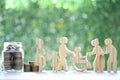 Mutual fund,Love couple senior and people on wheelchairs.pregnant woman with stack of coins money in glass bottle on natural green Royalty Free Stock Photo