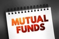 Mutual Funds - professionally managed investment fund that pools money from many investors to purchase securities, text on notepad Royalty Free Stock Photo