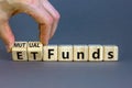 Mutual funds vs ETF symbol. Businessman turns a cube and changes words `ETF, Exchange-Traded Fund` to `Mutual funds. Beautiful Royalty Free Stock Photo