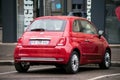 Rear view of red Fiat 500, the famous italian car parked in the street Royalty Free Stock Photo