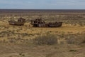 MUYNAQ, UZBEKISTAN - APRIL 22, 2018: People visit the ship graveyard in former Aral sea port town Moynaq Mo ynoq or Royalty Free Stock Photo