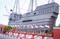 Muzium Samudera maritime museum in Malacca, Malaysia with flags in the foreground Royalty Free Stock Photo