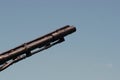 Muzzle barrel of naval ship artillery gun on a blue sky background. copy space, selective focus, narrow depth of field. Royalty Free Stock Photo