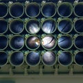 Muzzles barrels of military tank artillery gun on a blue sky background with child face. copy space, selective focus, narrow depth Royalty Free Stock Photo