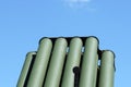 Muzzles barrels of military tank artillery gun on a blue sky background. copy space, selective focus, narrow depth of field.