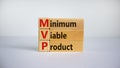 MVP, minimum viable product symbol. Wooden cubes and blocks with words MVP, minimum viable product. Beautiful white background. Royalty Free Stock Photo