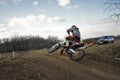 MX rider on rides mound performs scrub Royalty Free Stock Photo