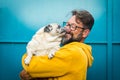 My best friend dog concept with funny scene adult man with beard and pug dog kissing him on the face - people and animals have fun Royalty Free Stock Photo