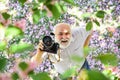 This is my best summer holiday ever. tourism and holiday. traveler camera man under sakura bloom garden. travel concept