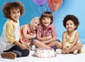 My birthday wish is to be friends forever. a group of children sitting around a birthday cake with bunch of balloons in Royalty Free Stock Photo