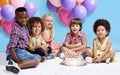 My birthday wish is to be friends forever. Shot of a group of children sitting around a birthday cake with bunch of Royalty Free Stock Photo