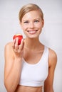 My body will thank me later. A portrait of a beautiful young woman eating a delicious red apple. Royalty Free Stock Photo