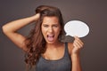 This is my boiling point. Studio shot of an attractive young woman holding a blank speech bubble and shouting against a