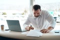 My customer is about to arrive. a young car salesman filling out paperwork in his office. Royalty Free Stock Photo