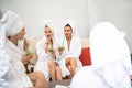 Lovely girls in bathrobes enjoying drinks and chatting Royalty Free Stock Photo